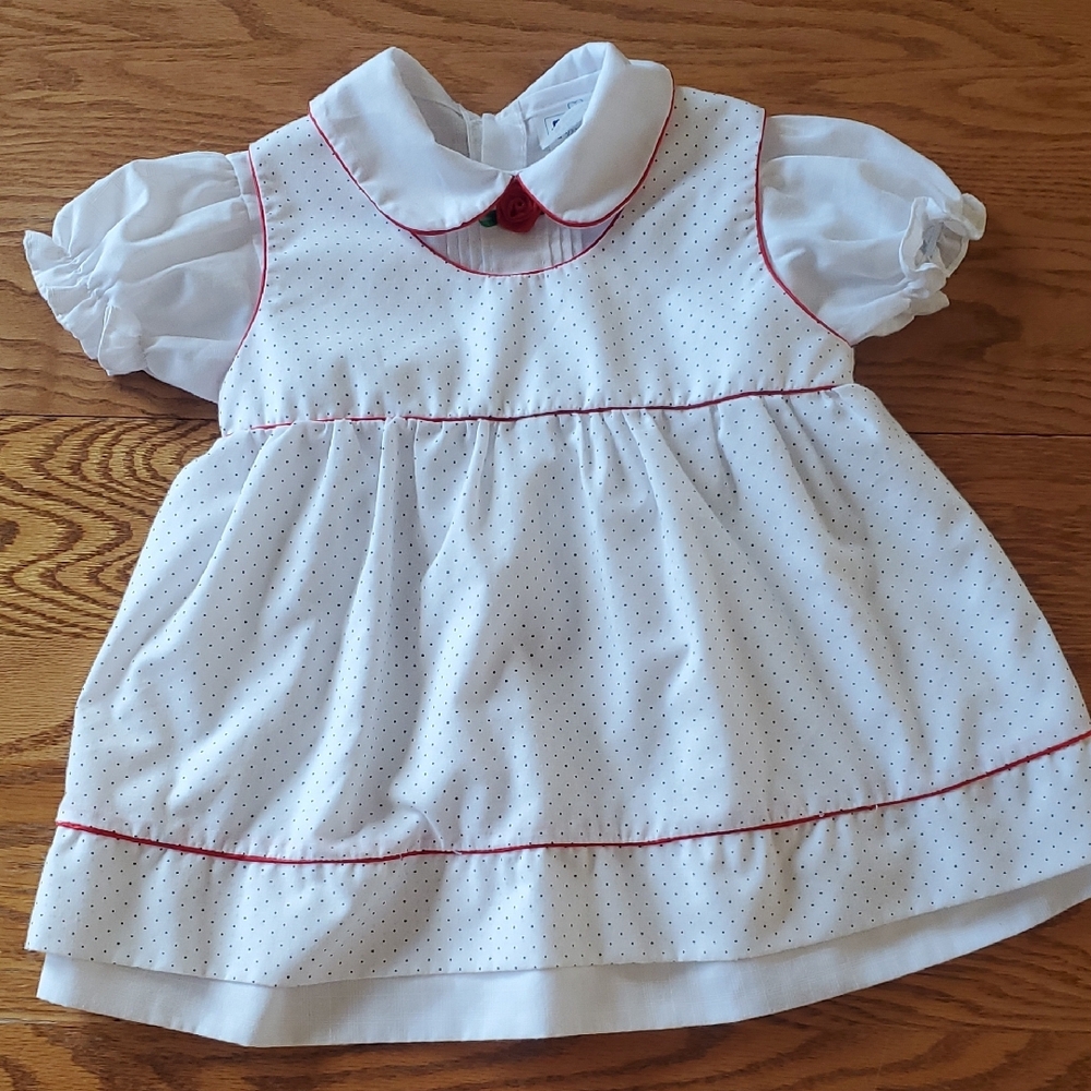 White baby dress with black pockadot pinafore